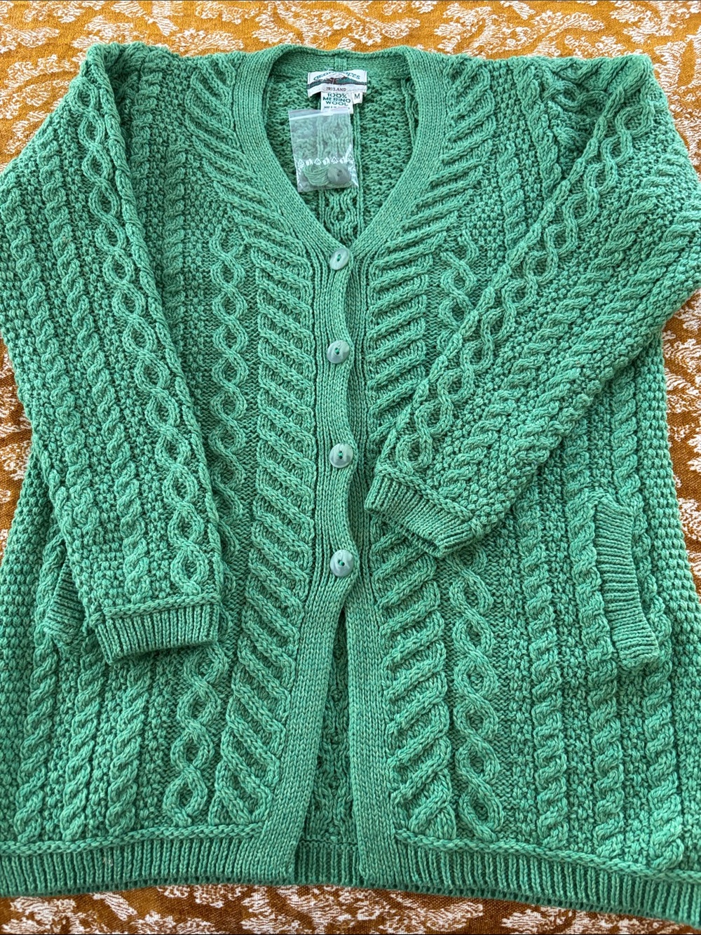 Aran Crafts long Merino cardigan, green, cables, pockets, size M